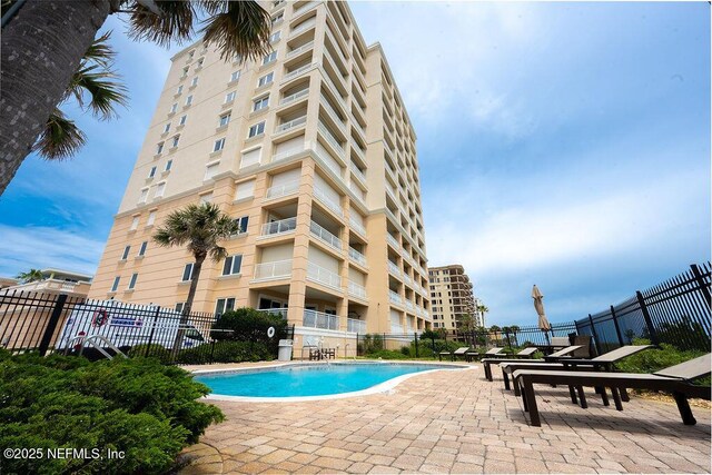 1201 1st St N Unit 1002, Jacksonville Beach, FL 32250 - community pool with a patio