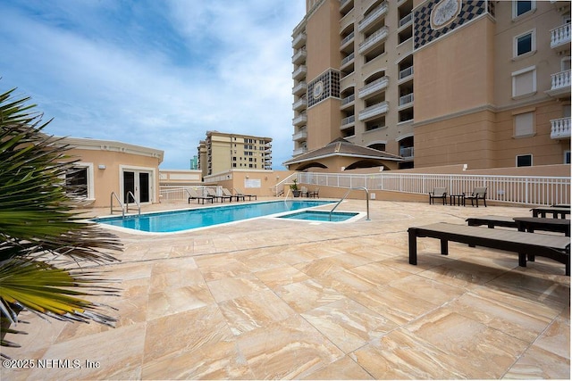 1201 1st St N Unit 1002, Jacksonville Beach, FL 32250 - community pool with a patio area and french doors