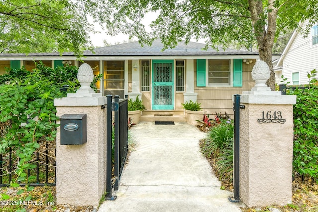 1643 Fishweir Creek Ln, Jacksonville, FL 32205 - view of front facade featuring a gate, a fenced front yard, and a shingled roof