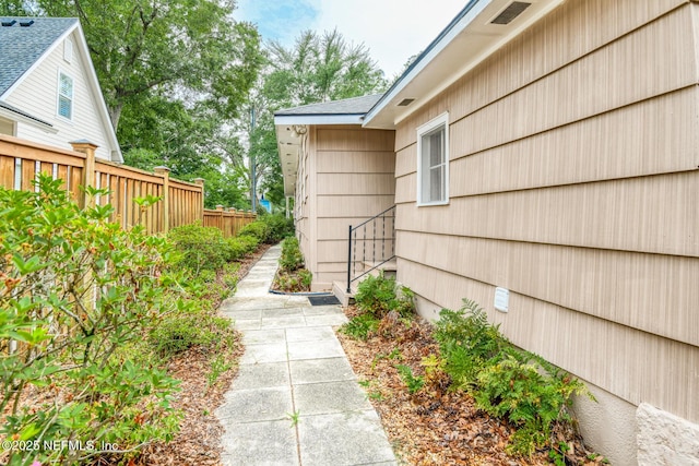 1643 Fishweir Creek Ln, Jacksonville, FL 32205 - view of exterior entry with a shingled roof