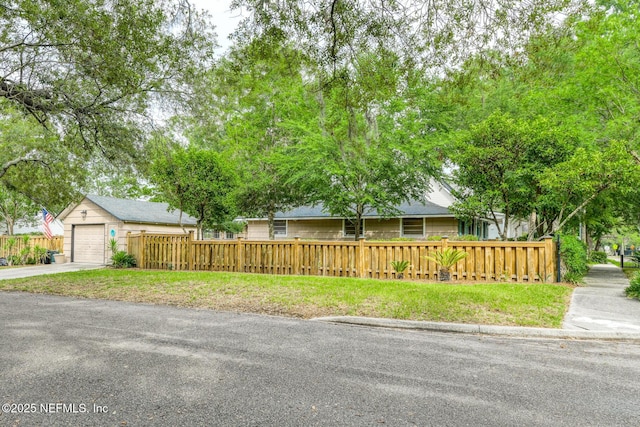 1643 Fishweir Creek Ln, Jacksonville, FL 32205 - view of front of home featuring a fenced front yard, concrete driveway, and a garage