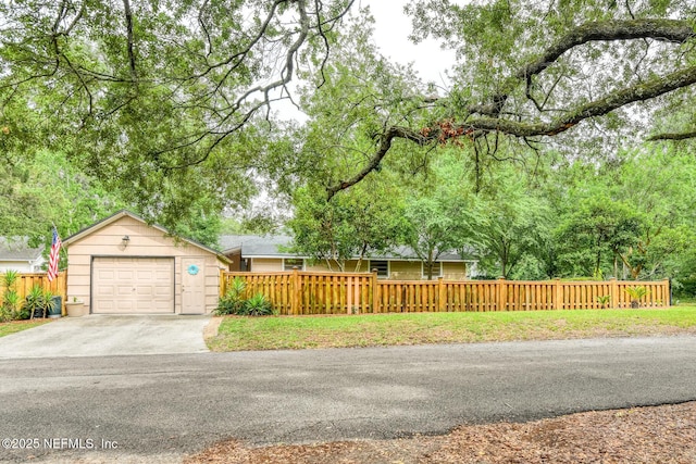 1643 Fishweir Creek Ln, Jacksonville, FL 32205 - view of front of property with a fenced front yard, concrete driveway, and a garage