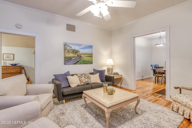 1643 Fishweir Creek Ln, Jacksonville, FL 32205 - living area featuring light wood finished floors, crown molding, ceiling fan, and baseboards