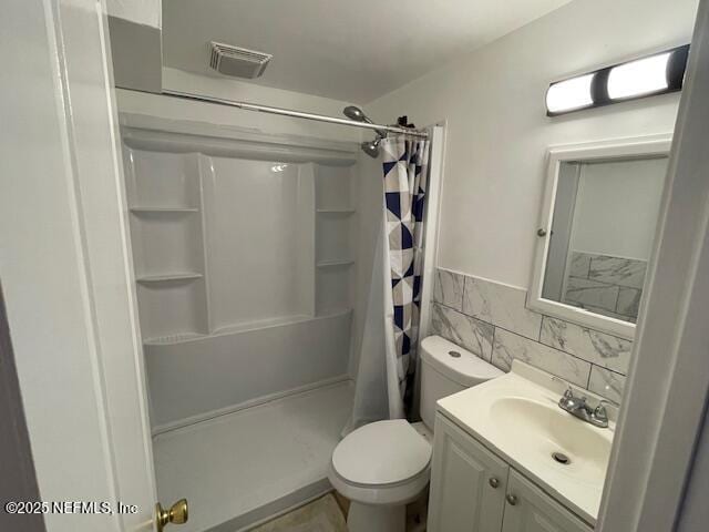 843 Line St, Jacksonville, FL 32209 - bathroom featuring a shower stall, vanity, tile walls, and toilet