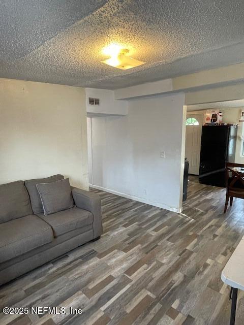 843 Line St, Jacksonville, FL 32209 - living room featuring wood finished floors and a textured ceiling