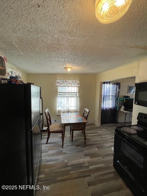 843 Line St, Jacksonville, FL 32209 - dining area featuring a textured ceiling and wood finished floors