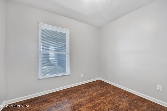 8390 Scottish Ct, Jacksonville, FL 32244 - empty room with dark wood-style floors and baseboards