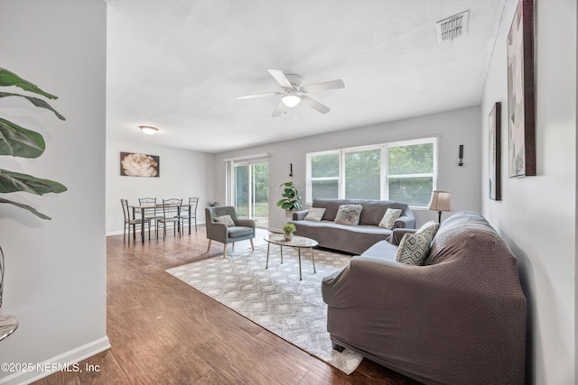 8390 Scottish Ct, Jacksonville, FL 32244 - living room featuring a ceiling fan, wood finished floors, and baseboards