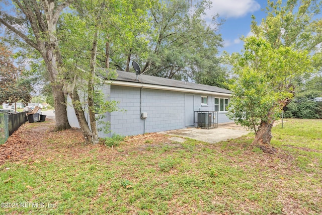 8390 Scottish Ct, Jacksonville, FL 32244 - back of house with a patio area, concrete block siding, and central AC