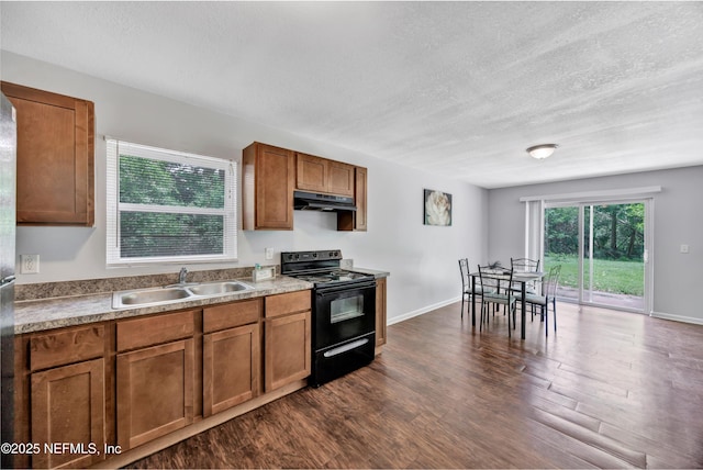 8390 Scottish Ct, Jacksonville, FL 32244 - kitchen with black electric range, under cabinet range hood, a sink, brown cabinetry, and a textured ceiling