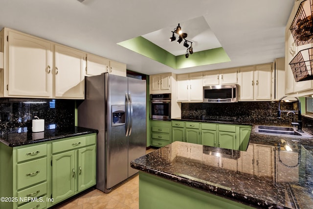 3111 Old Port Cir E, Jacksonville, FL 32216 - kitchen featuring stainless steel appliances, a raised ceiling, tasteful backsplash, and green cabinetry