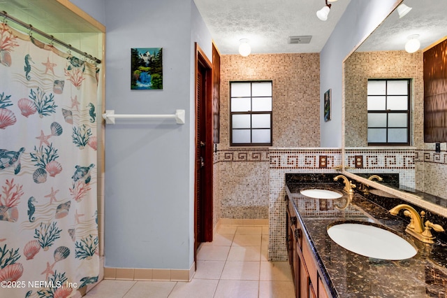 3111 Old Port Cir E, Jacksonville, FL 32216 - full bath with double vanity, tile patterned flooring, a textured ceiling, and a shower with shower curtain