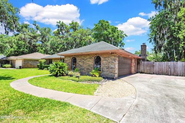 3111 Old Port Cir E, Jacksonville, FL 32216 - view of front facade featuring brick siding, a garage, driveway, and a chimney