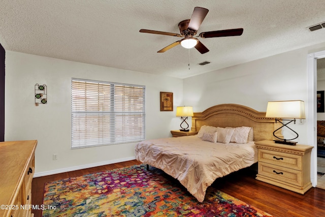 3111 Old Port Cir E, Jacksonville, FL 32216 - bedroom featuring dark wood-type flooring, a textured ceiling, baseboards, and a ceiling fan