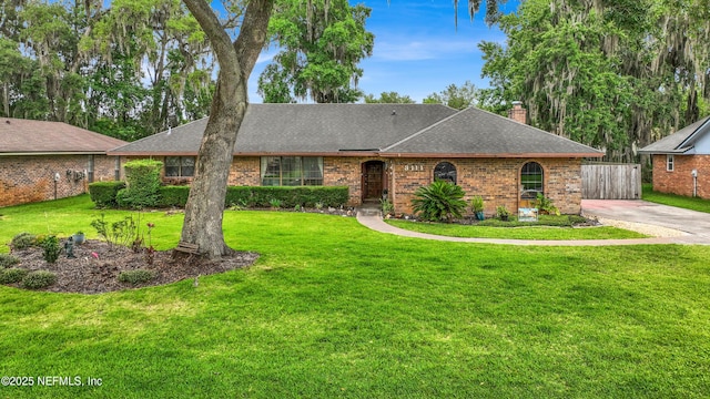 3111 Old Port Cir E, Jacksonville, FL 32216 - view of front of house with a chimney, a shingled roof, and brick siding