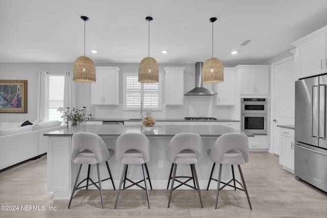 45 Lantern Post Way, Ponte Vedra, FL 32081 - kitchen featuring wall chimney range hood, stainless steel appliances, decorative backsplash, white cabinetry, and recessed lighting