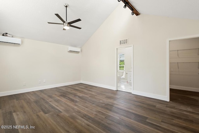 2605 Spreading Oaks Ln, Jacksonville, FL 32223 - unfurnished room with a wall mounted AC, ceiling fan, rail lighting, dark wood finished floors, and baseboards