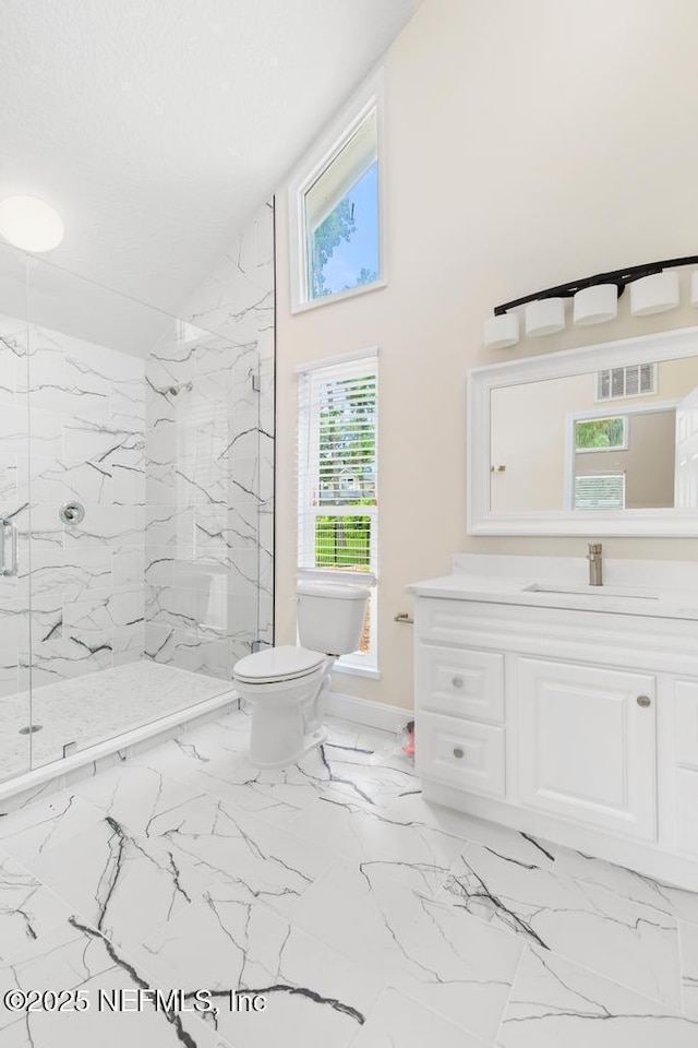 2605 Spreading Oaks Ln, Jacksonville, FL 32223 - bathroom with a marble finish shower, toilet, vanity, marble finish floors, and baseboards