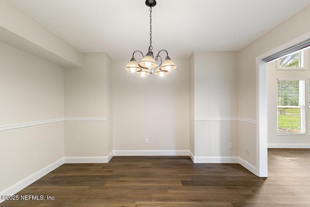 2605 Spreading Oaks Ln, Jacksonville, FL 32223 - spare room with wood finished floors, a chandelier, and baseboards