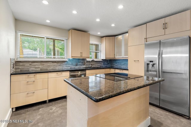 2605 Spreading Oaks Ln, Jacksonville, FL 32223 - kitchen featuring appliances with stainless steel finishes, a sink, decorative backsplash, recessed lighting, and dark stone countertops