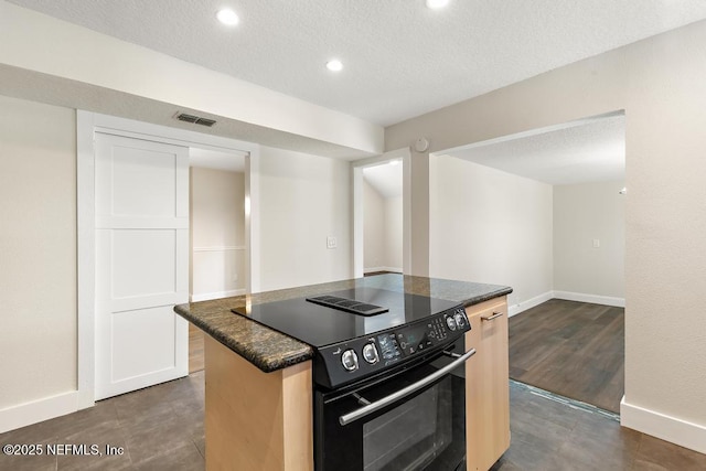 2605 Spreading Oaks Ln, Jacksonville, FL 32223 - kitchen featuring black range with electric stovetop, baseboards, a center island, recessed lighting, and a textured ceiling