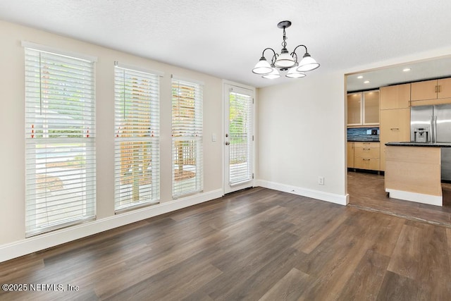 2605 Spreading Oaks Ln, Jacksonville, FL 32223 - unfurnished dining area with a chandelier, dark wood finished floors, baseboards, and recessed lighting