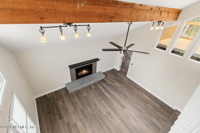 2605 Spreading Oaks Ln, Jacksonville, FL 32223 - unfurnished living room featuring wood finished floors, baseboards, a warm lit fireplace, a ceiling fan, and beamed ceiling