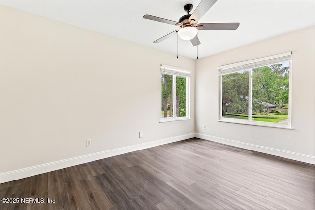 2605 Spreading Oaks Ln, Jacksonville, FL 32223 - unfurnished room featuring plenty of natural light, ceiling fan, and dark wood-style flooring