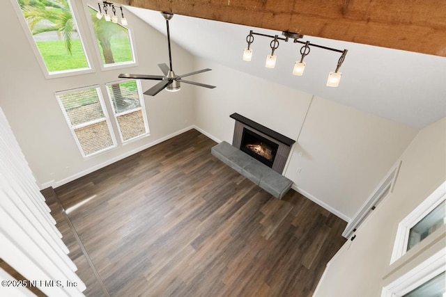 2605 Spreading Oaks Ln, Jacksonville, FL 32223 - unfurnished living room with lofted ceiling, ceiling fan, a warm lit fireplace, wood finished floors, and baseboards