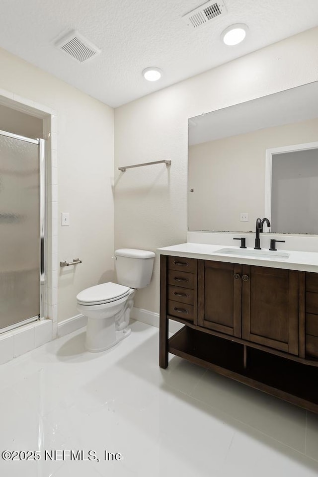 2605 Spreading Oaks Ln, Jacksonville, FL 32223 - full bath featuring toilet, vanity, a stall shower, baseboards, and a textured ceiling