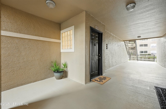 1655 The Greens Way Unit 2612, Jacksonville Beach, FL 32250 - view of exterior entry with stucco siding and covered porch
