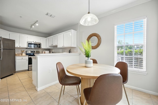 1655 The Greens Way Unit 2612, Jacksonville Beach, FL 32250 - dining space featuring plenty of natural light, light tile patterned floors, baseboards, and crown molding