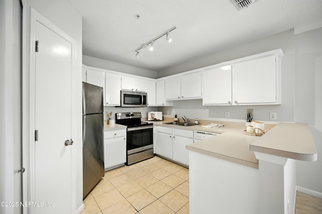 1655 The Greens Way Unit 2612, Jacksonville Beach, FL 32250 - kitchen featuring stainless steel appliances, a sink, a peninsula, light countertops, and light tile patterned floors