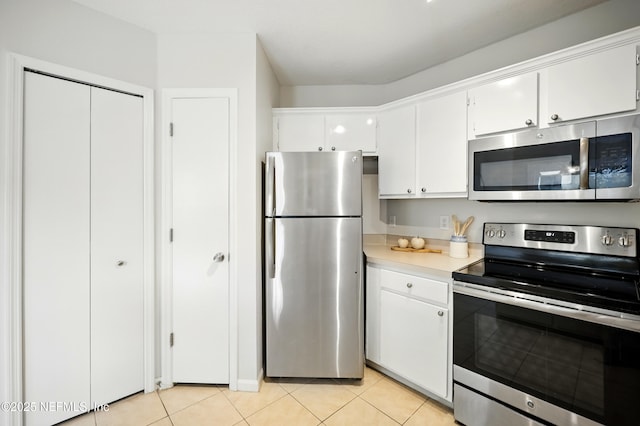 1655 The Greens Way Unit 2612, Jacksonville Beach, FL 32250 - kitchen featuring stainless steel appliances, light countertops, and white cabinets