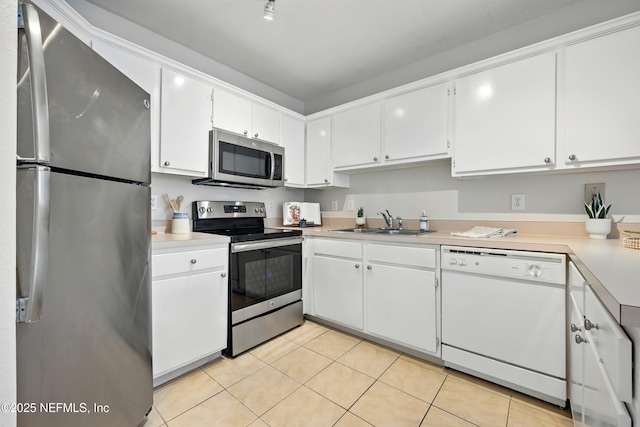 1655 The Greens Way Unit 2612, Jacksonville Beach, FL 32250 - kitchen with appliances with stainless steel finishes, a sink, white cabinetry, light tile patterned floors, and light countertops