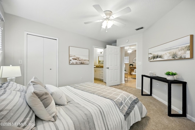1655 The Greens Way Unit 2612, Jacksonville Beach, FL 32250 - bedroom with light colored carpet, a closet, ensuite bath, a ceiling fan, and baseboards