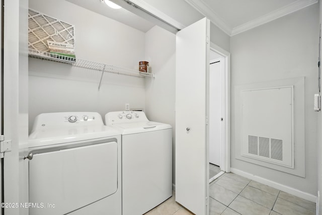1655 The Greens Way Unit 2612, Jacksonville Beach, FL 32250 - laundry area featuring washer and dryer, crown molding, light tile patterned flooring, and baseboards