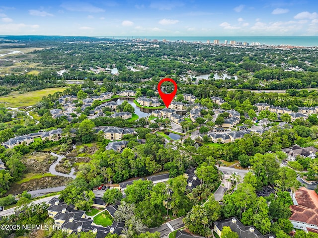 1655 The Greens Way Unit 2612, Jacksonville Beach, FL 32250 - aerial overview of property's location featuring a large body of water, nearby suburban area, and a tree filled landscape