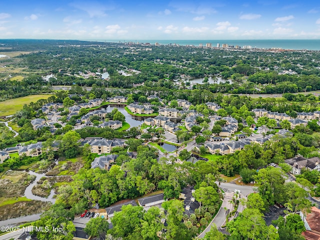 1655 The Greens Way Unit 2612, Jacksonville Beach, FL 32250 - aerial view of residential area featuring a large body of water and a tree filled landscape