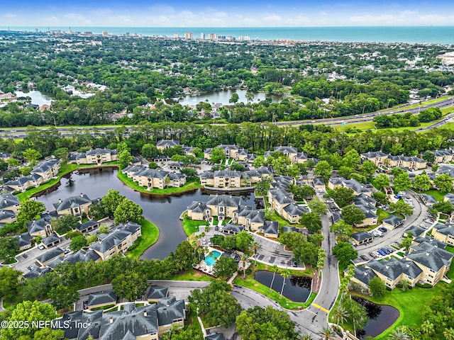 1655 The Greens Way Unit 2612, Jacksonville Beach, FL 32250 - aerial perspective of suburban area with a nearby body of water and a tree filled landscape