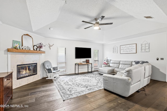 918 Arkenstone Dr, Jacksonville, FL 32225 - living area featuring a raised ceiling, ceiling fan, a textured ceiling, dark wood-style floors, and a fireplace