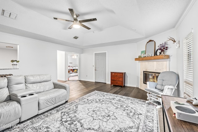 918 Arkenstone Dr, Jacksonville, FL 32225 - living room with ceiling fan, wood finished floors, a premium fireplace, a tray ceiling, and crown molding