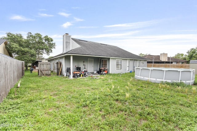 918 Arkenstone Dr, Jacksonville, FL 32225 - back of property featuring a chimney and roof with shingles