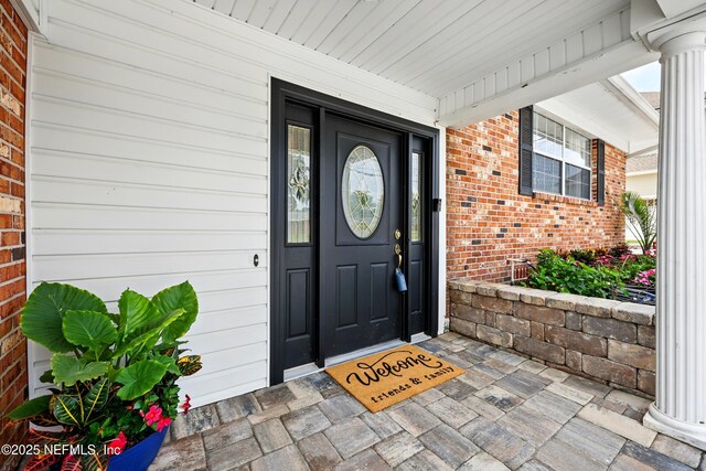 276 Baisden Rd, Jacksonville, FL 32218 - entrance to property featuring brick siding and covered porch