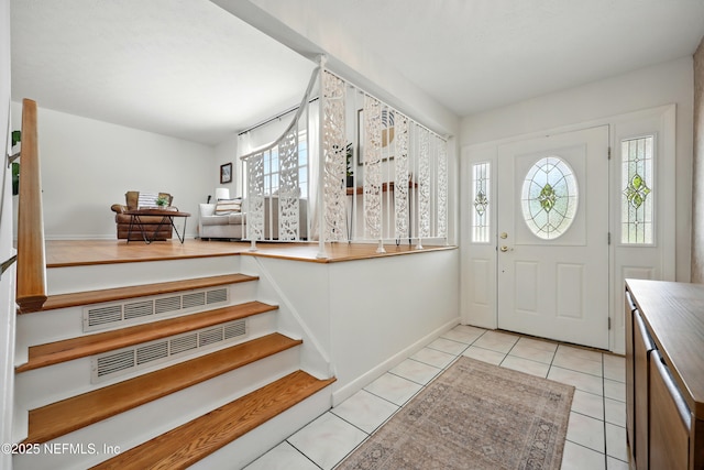 276 Baisden Rd, Jacksonville, FL 32218 - foyer entrance featuring light tile patterned floors, stairs, and baseboards