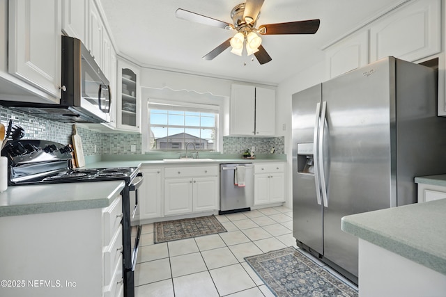 276 Baisden Rd, Jacksonville, FL 32218 - kitchen with appliances with stainless steel finishes, a sink, light tile patterned floors, tasteful backsplash, and a ceiling fan