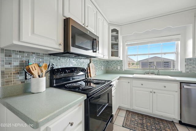 276 Baisden Rd, Jacksonville, FL 32218 - kitchen featuring appliances with stainless steel finishes, a sink, white cabinetry, and tasteful backsplash