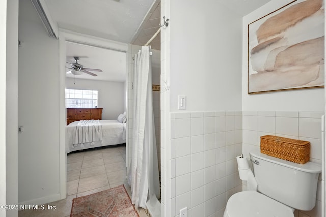 276 Baisden Rd, Jacksonville, FL 32218 - ensuite bathroom featuring toilet, a shower with curtain, ceiling fan, tile patterned floors, and tile walls