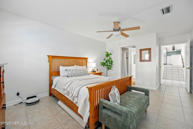 276 Baisden Rd, Jacksonville, FL 32218 - bedroom with light tile patterned floors, baseboards, ensuite bath, and a ceiling fan