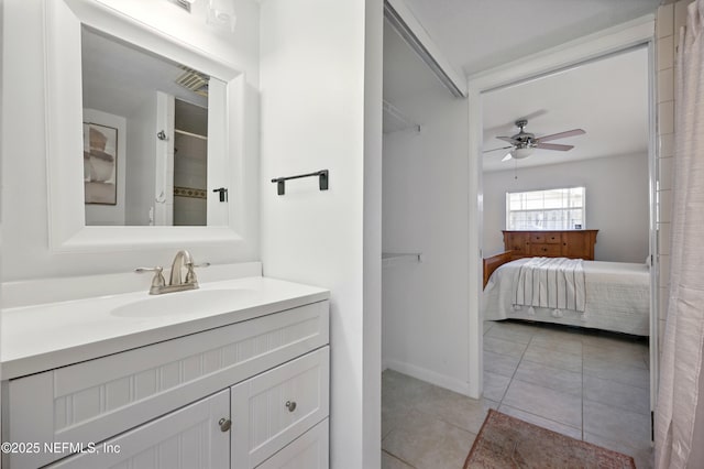 276 Baisden Rd, Jacksonville, FL 32218 - bathroom with vanity, tile patterned flooring, a ceiling fan, connected bathroom, and baseboards